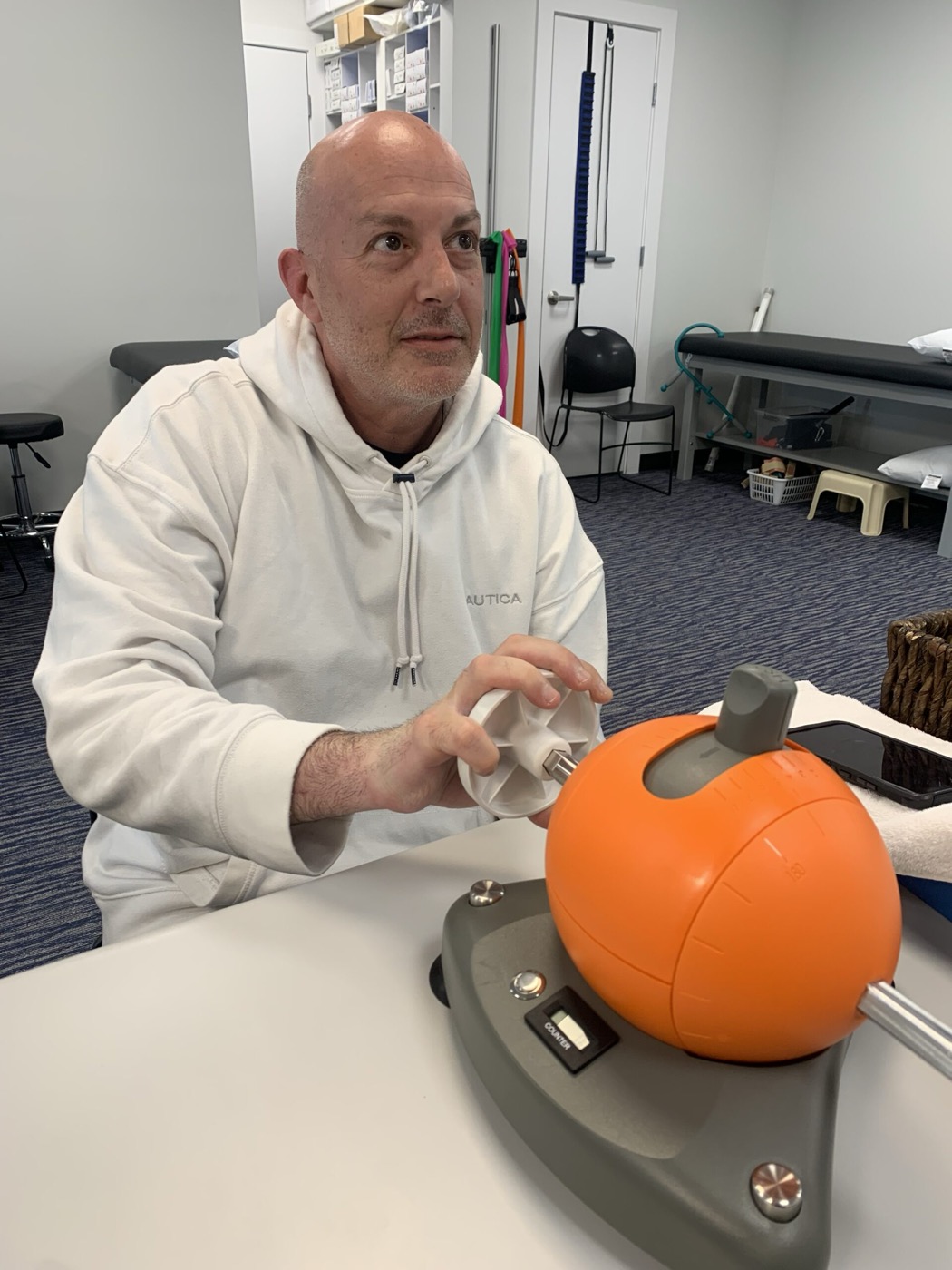 C.J. Allen demonstrating wrist rotation therapy equipment