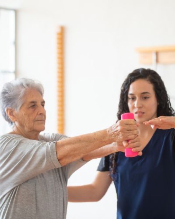 Occupational therapist assisting a patient with a shoulder exercise
