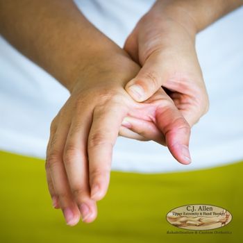 A person uses one hand to gently grasp and massage the base of their opposite thumb, possibly indicating discomfort or pain. A person uses one hand to gently grasp and massage the base of their opposite thumb, possibly indicating discomfort or pain